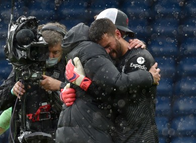 Alisson is embraced by Jurgen Klopp after the game.