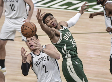 Milwaukee Bucks forward Giannis Antetokounmpo (34) and Brooklyn Nets forward Blake Griffin (2) reach for a rebound.
