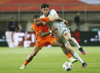 Netherlands' Memphis Depay challenges for the ball with Scotland's Scott McKenna.