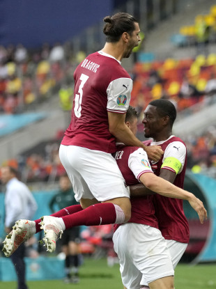 Austria's Christoph Baumgartner, centre, celebrates with team-mates David Alaba, right, and Aleksandar Dragovic after scoring.