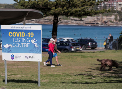 A couple walking their dog near a Covid-19 testing centre in Sydney, Australia