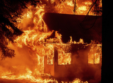 : Flames consume a home as the Dixie Fire tears through the Indian Falls community in Plumas County, California.