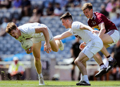 Kildare’s Kevin Feely and Mick O’Grady with John Heslin of Westmeath.