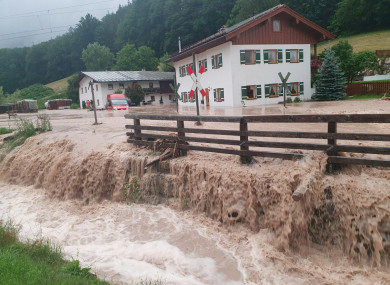 Water flows over a square in front of a house in Bavaria