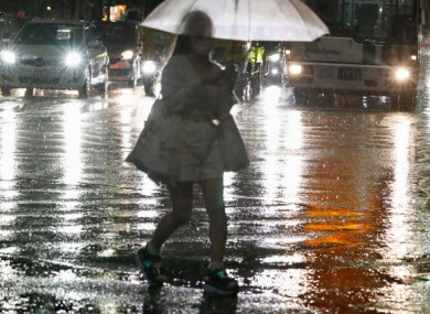 A woman makes her way through heavy rain in Fukuoka, western Japan