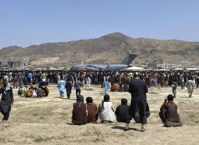 Hundreds of people gather near a US Air Force C-17 transport plane at Kabul airport on Monday.
