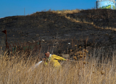 Fields burn following a hit by a rocket fired from Lebanon into Israeli territory, near the northern Israeli town of Kiryat Shmona.