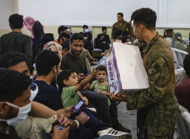US marine hands out water to evacuees at Hamid Karzai International Airport in Kabul.
