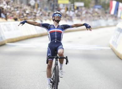Alaphilippe celebrates as he crosses the finish line.