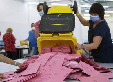 Election workers prepare to count absentee ballots in Munich today.