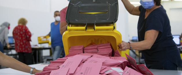 Election workers prepare to count absentee ballots in Munich today.