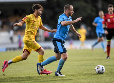 Josh Cavallo (left) of Adelaide United chases Rhyan Grant of Sydney.