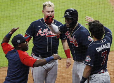 Jorge Soler celebrates with his Braves teammates after hitting a home run in the 1st inning of Game One.