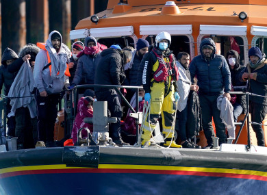 Migrants, rescued in the English Channel, arrive onboard a lifeboat into Dover.