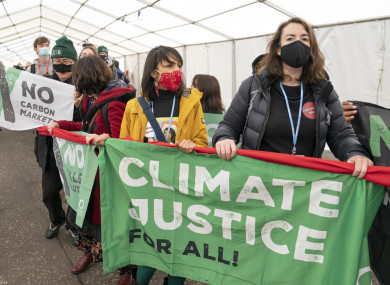Protesters leaving the main area of the COP26 summit earlier today.