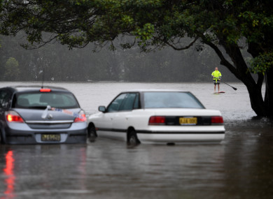 Flooding from a swollen Manly Creek is seen inundating cars and the street at Campbell Parade, in Manly Vale, north of Sydney