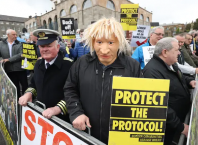A man dressed as a customs officer and another dressed as Boris Johnson with protesters from Border Communities Against Brexit outside Hillsborough Castle.