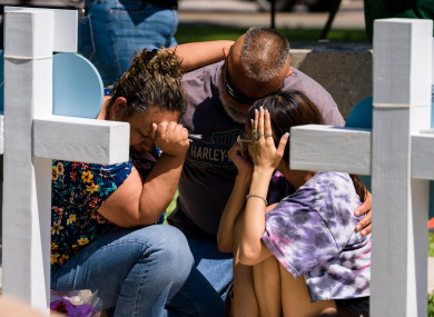 The family of Alexandria Rubio grieves in front of a memorial for Rubio and other victims of the Robb Elementary School shooting in Uvalde, Texas.