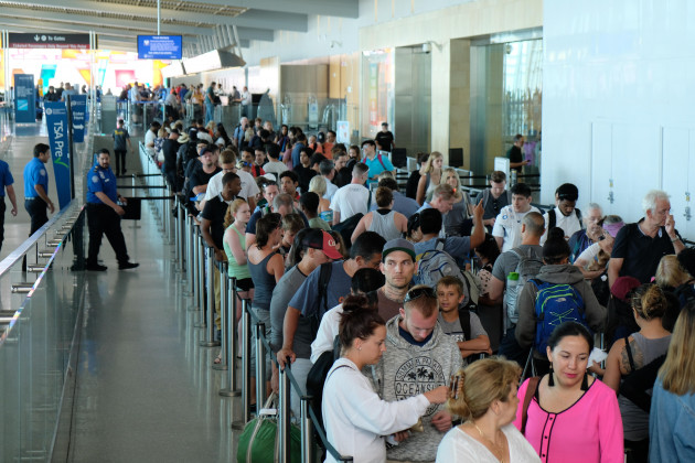 I pride myself on being a lickarse in the airport security queue. The person in front of me is not