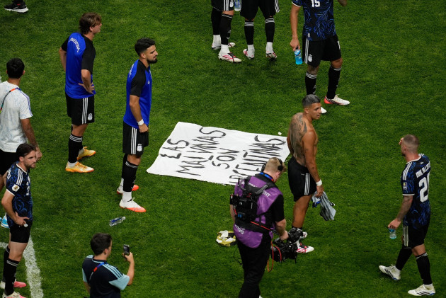 Argentina players celebrate with ‘Falklands are ours’ sign after putting England out of World Cup